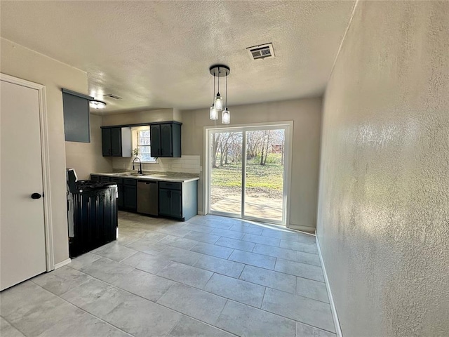 kitchen featuring pendant lighting, dishwasher, sink, electric range, and tasteful backsplash