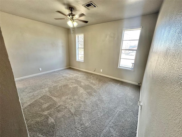 carpeted empty room featuring plenty of natural light and ceiling fan