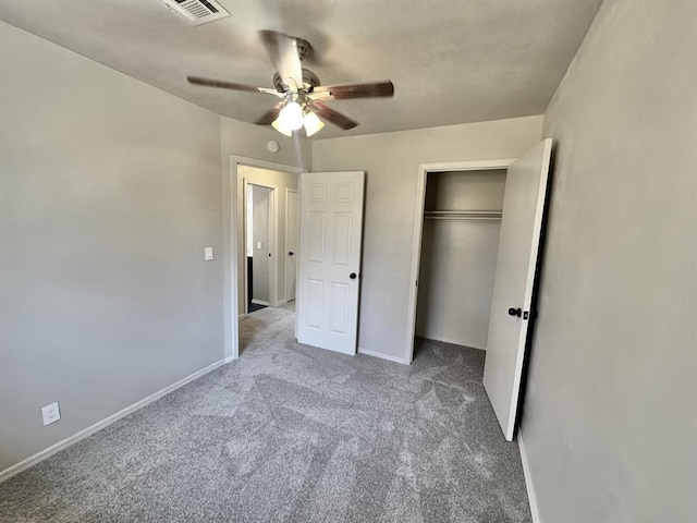 unfurnished bedroom with light carpet, a closet, and ceiling fan