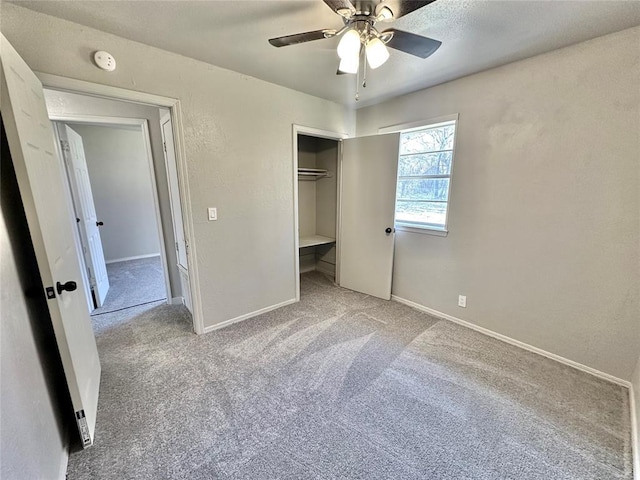 unfurnished bedroom featuring ceiling fan, a closet, and light carpet