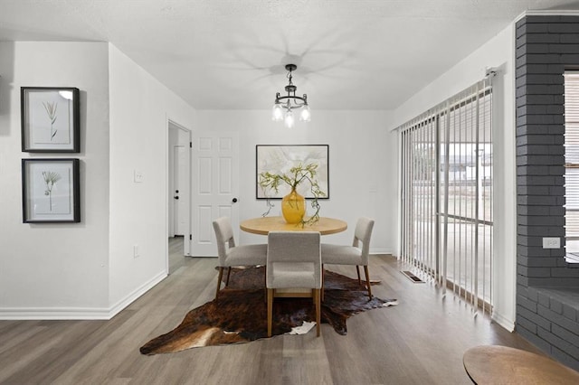 dining room with an inviting chandelier and hardwood / wood-style flooring