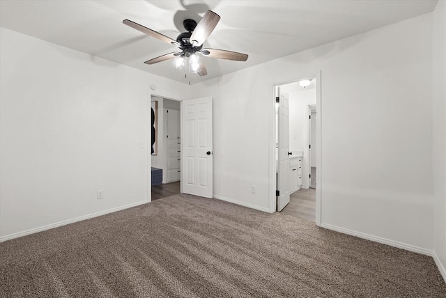 unfurnished bedroom with ceiling fan, carpet floors, and ensuite bath