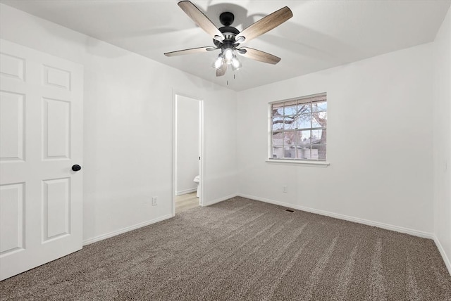 unfurnished bedroom with ceiling fan, ensuite bath, and carpet floors