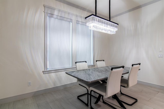 dining area featuring an inviting chandelier and light hardwood / wood-style flooring