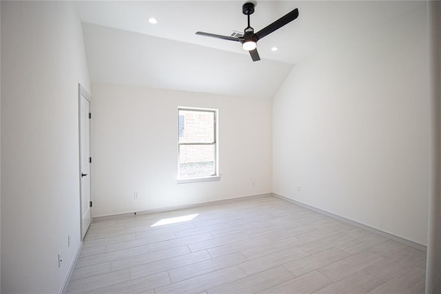 spare room featuring vaulted ceiling and ceiling fan