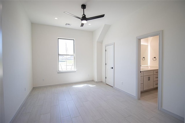 unfurnished bedroom featuring ceiling fan and ensuite bathroom