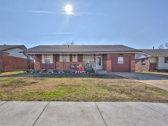 single story home with covered porch and a front lawn