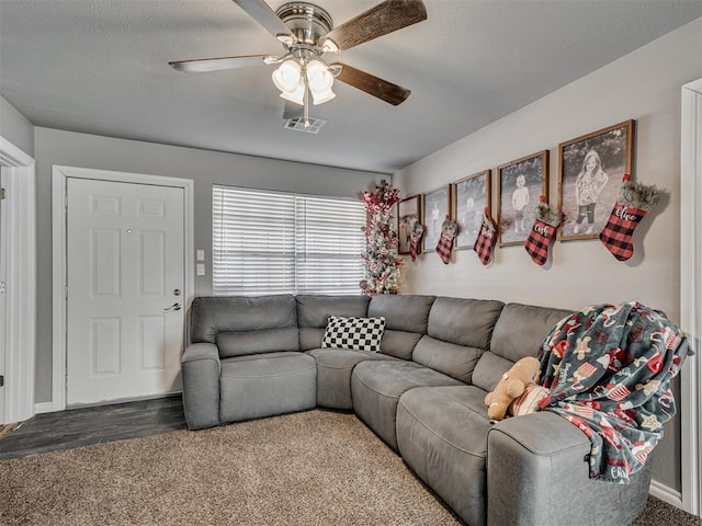 carpeted living room with ceiling fan