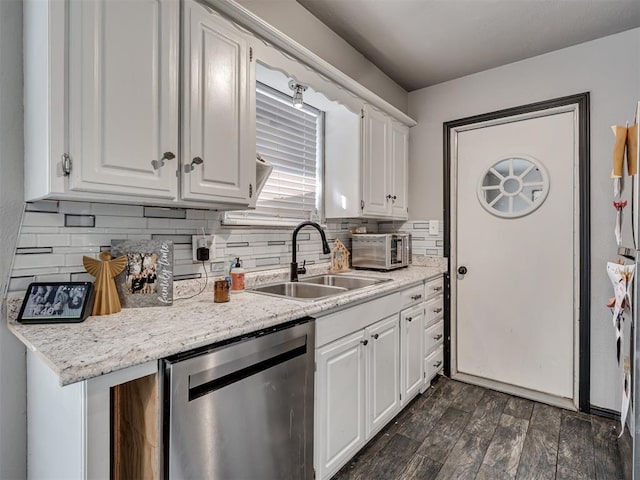 kitchen featuring light stone countertops, dishwasher, sink, decorative backsplash, and white cabinets