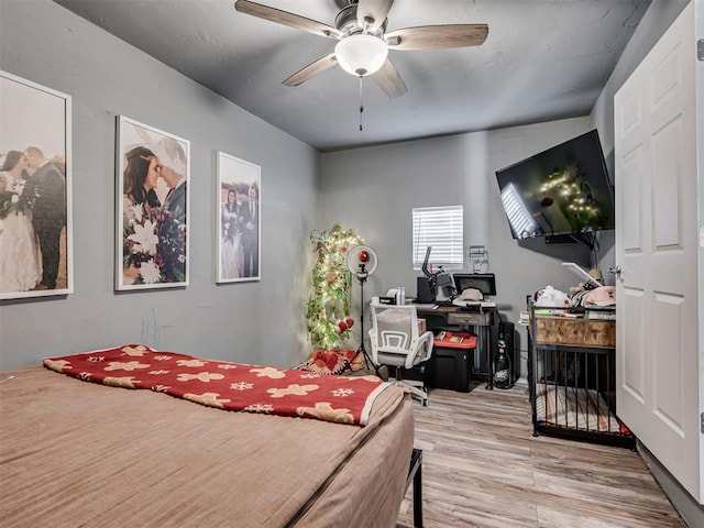 bedroom with ceiling fan and light wood-type flooring