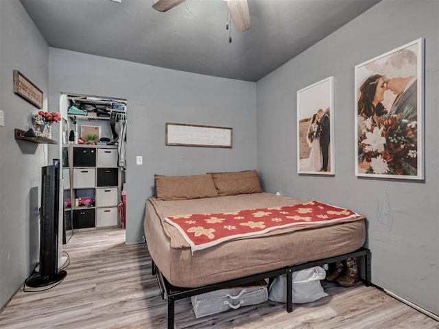 bedroom with ceiling fan and light hardwood / wood-style flooring