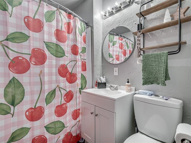 bathroom featuring a shower with curtain, vanity, and toilet