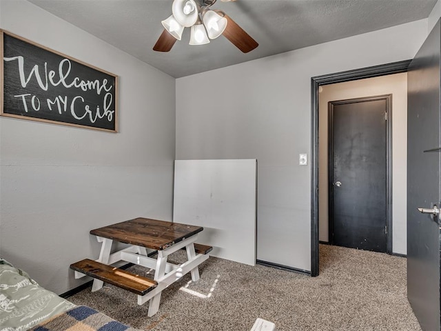 carpeted dining area featuring ceiling fan