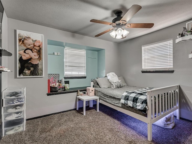 bedroom featuring carpet flooring, ceiling fan, a textured ceiling, and multiple windows