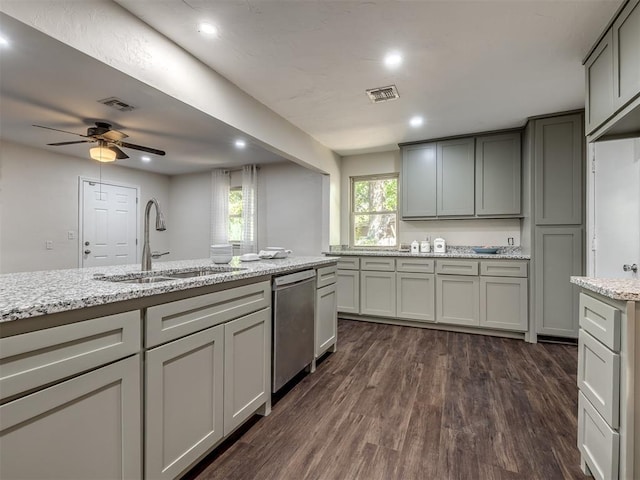 kitchen featuring gray cabinetry, dark wood-type flooring, sink, stainless steel dishwasher, and light stone countertops