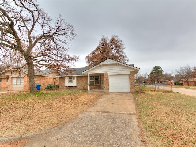 ranch-style home with a front lawn and a garage