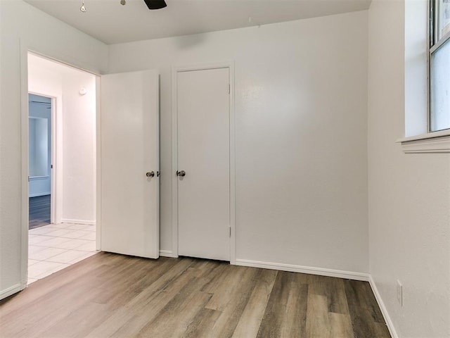 unfurnished bedroom featuring ceiling fan and light hardwood / wood-style flooring