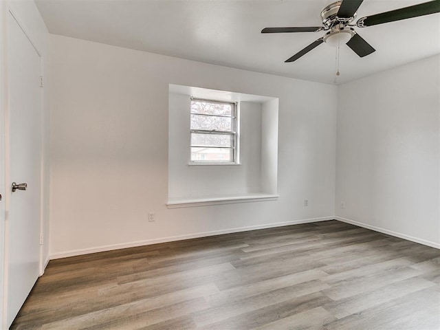 spare room featuring hardwood / wood-style flooring and ceiling fan