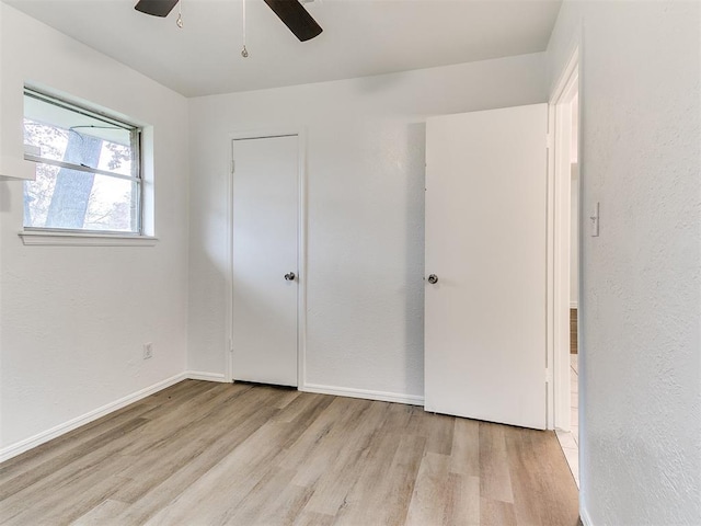 unfurnished bedroom with light hardwood / wood-style floors and ceiling fan