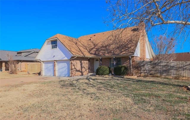 view of front of house with a front lawn and a garage