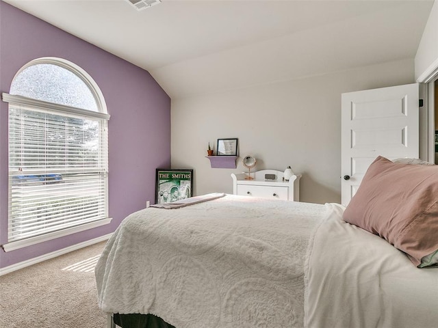 carpeted bedroom with vaulted ceiling