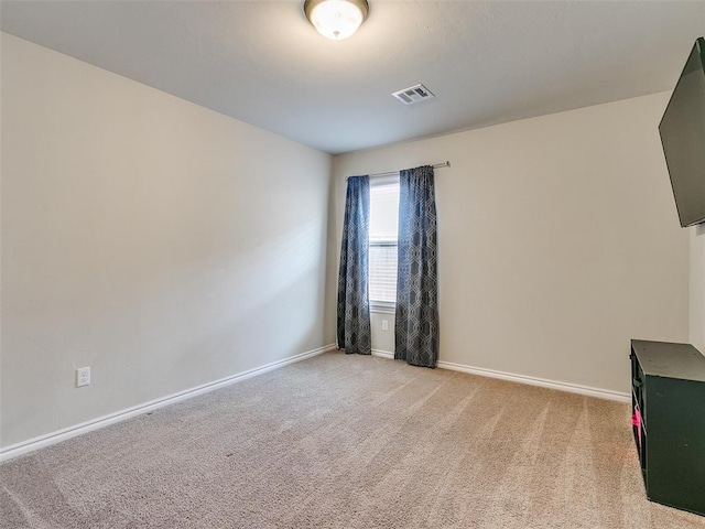 unfurnished room with light carpet