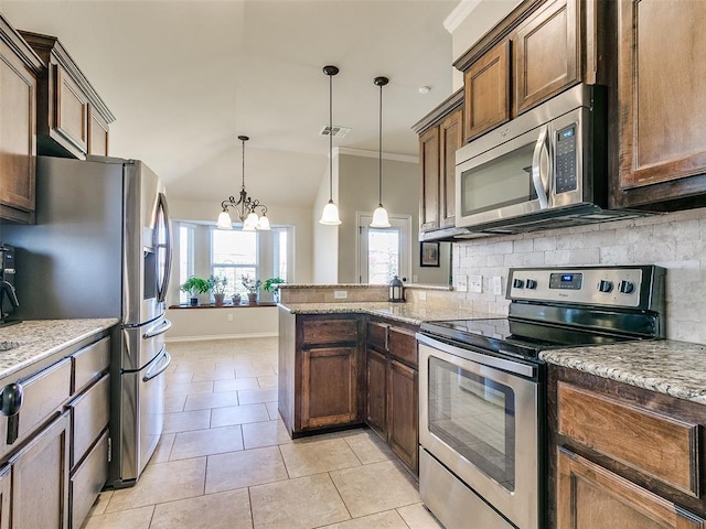 kitchen with hanging light fixtures, light tile patterned floors, a notable chandelier, light stone counters, and stainless steel appliances