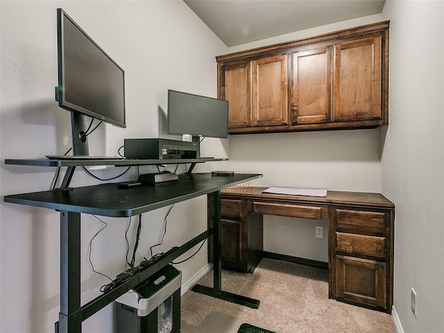 office featuring lofted ceiling and light carpet