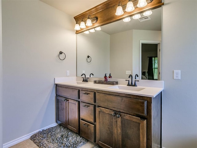 bathroom with tile patterned flooring and vanity