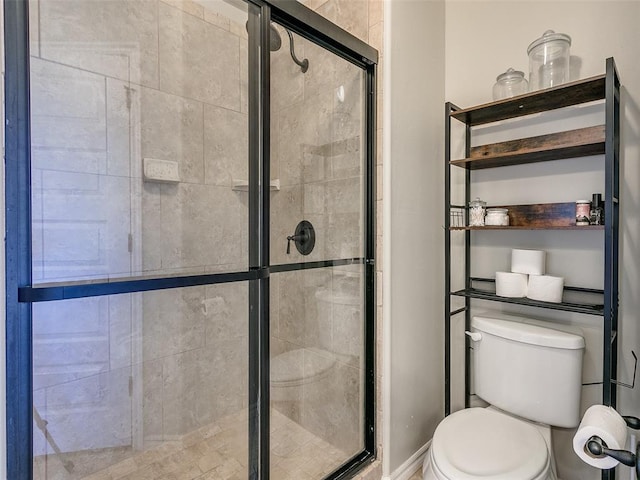 bathroom featuring toilet and walk in shower