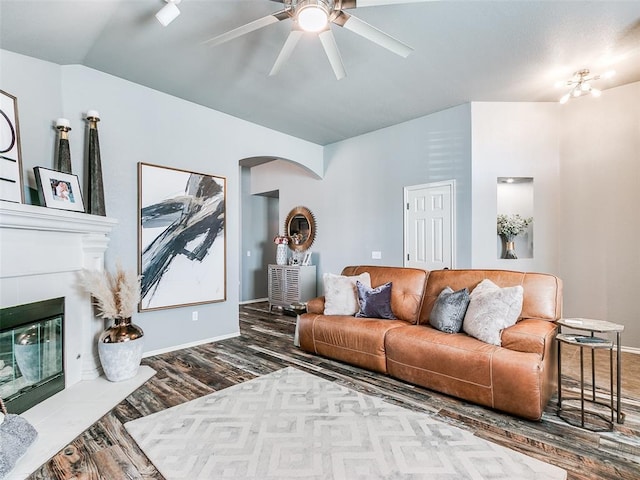 living room featuring ceiling fan, hardwood / wood-style floors, and lofted ceiling