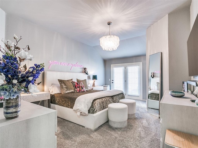 carpeted bedroom with a chandelier