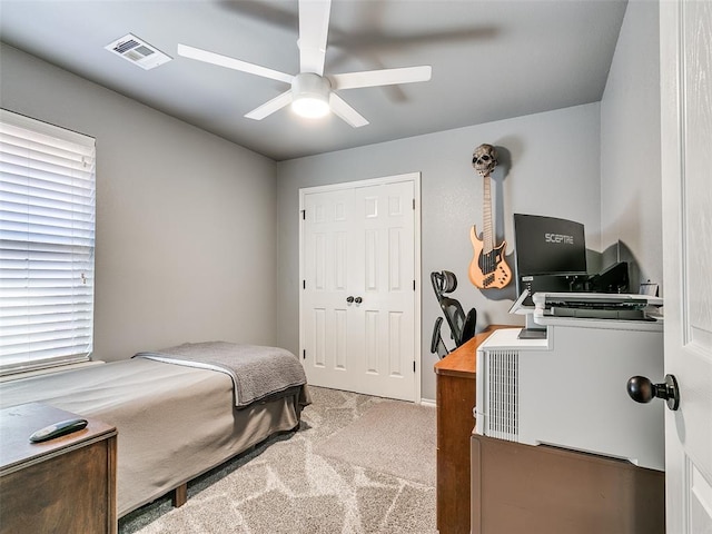 bedroom featuring ceiling fan and light colored carpet