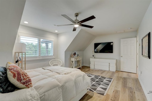 bedroom featuring light hardwood / wood-style floors, vaulted ceiling, and ceiling fan