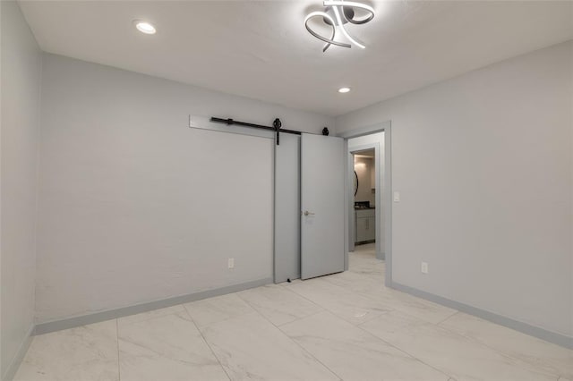 spare room featuring a barn door