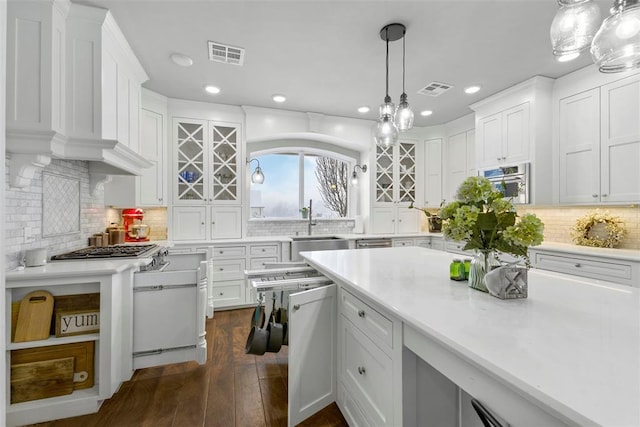 kitchen with white cabinetry, hanging light fixtures, and dark wood-type flooring