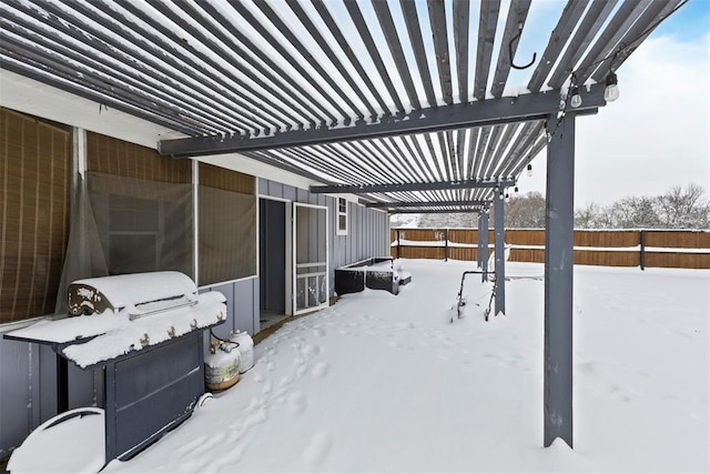 snow covered patio with a pergola