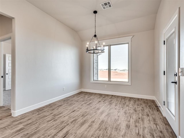 unfurnished dining area featuring a chandelier, light hardwood / wood-style flooring, and vaulted ceiling