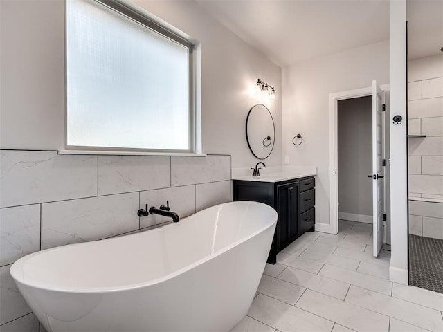 bathroom with a bathing tub and vanity