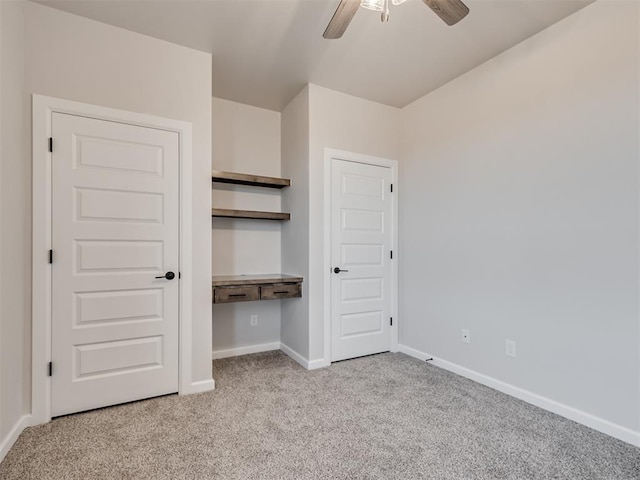 unfurnished bedroom featuring light carpet, a closet, and ceiling fan