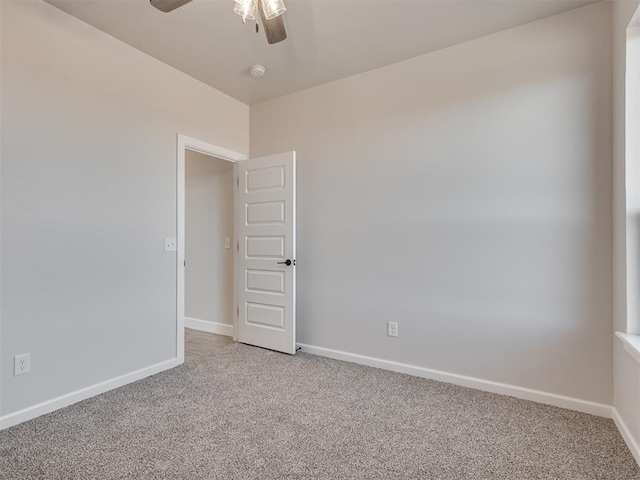 carpeted empty room with ceiling fan