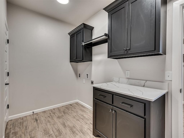 clothes washing area featuring cabinets, hookup for a washing machine, light wood-type flooring, and electric dryer hookup