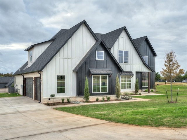 modern farmhouse with central AC, a garage, and a front lawn