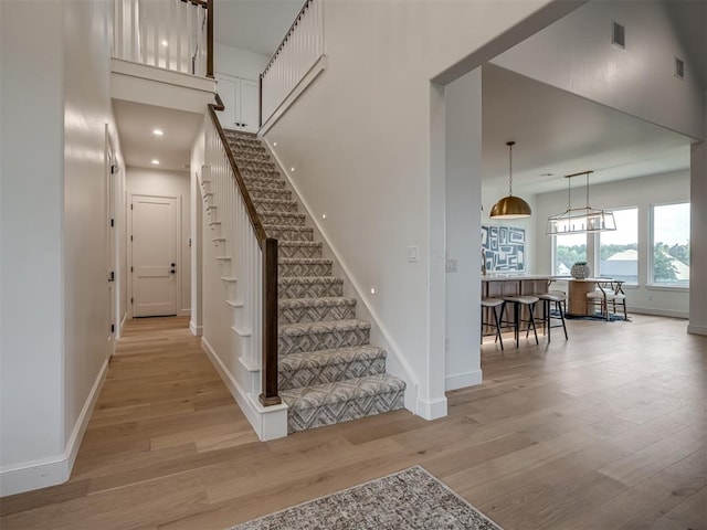 stairs featuring wood-type flooring