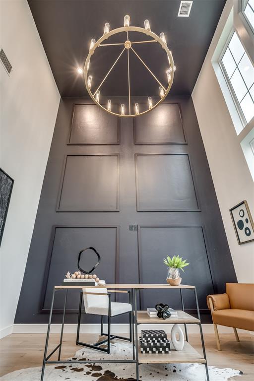 details with hardwood / wood-style flooring and a notable chandelier