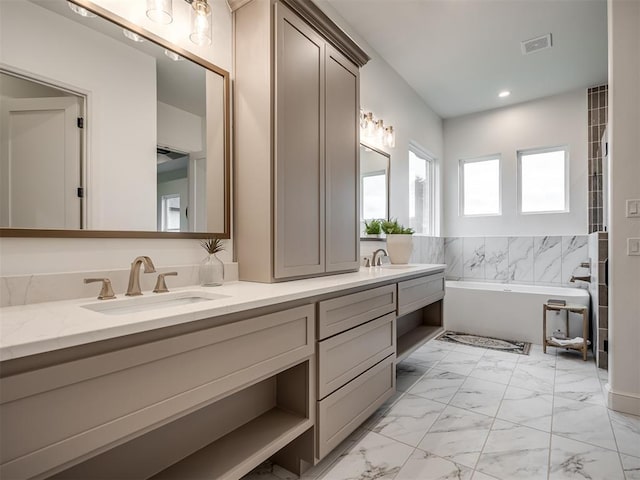 bathroom featuring a washtub and vanity