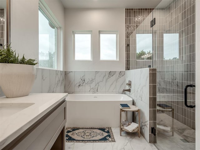 bathroom featuring vanity, tile walls, and independent shower and bath