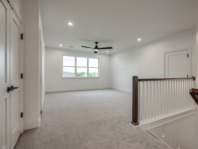 carpeted empty room featuring ceiling fan