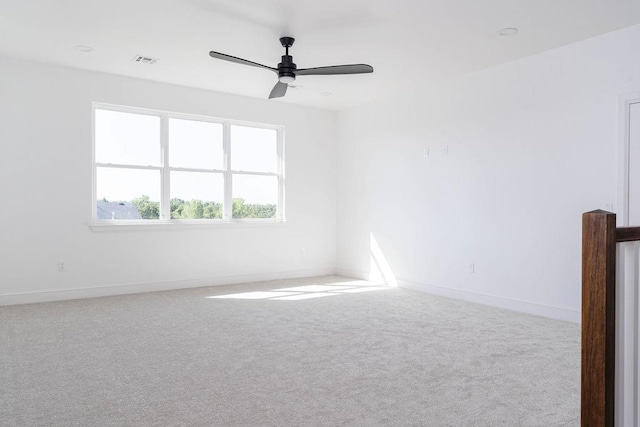 carpeted spare room with ceiling fan