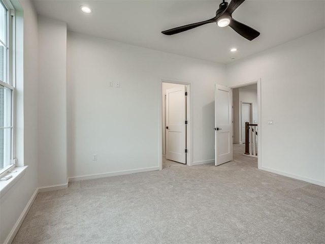 carpeted empty room featuring ceiling fan